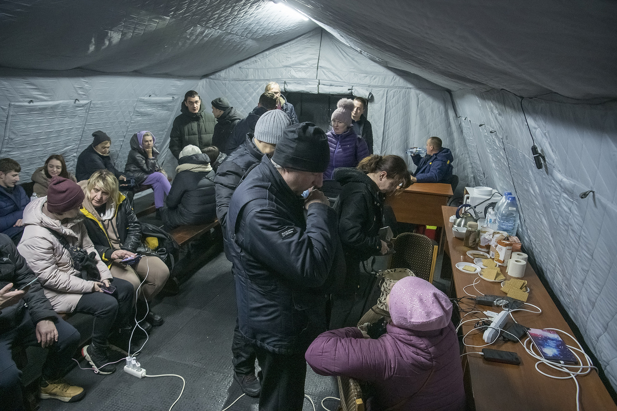 Local residents charge their devices, use internet connection and warm up inside  Centre of Invincibility after critical civil infrastructure was hit by Russian missile attacks in Kyiv, Ukraine November 24, 2022. (Photo by Maxym Marusenko/NurPhoto via Getty Images)