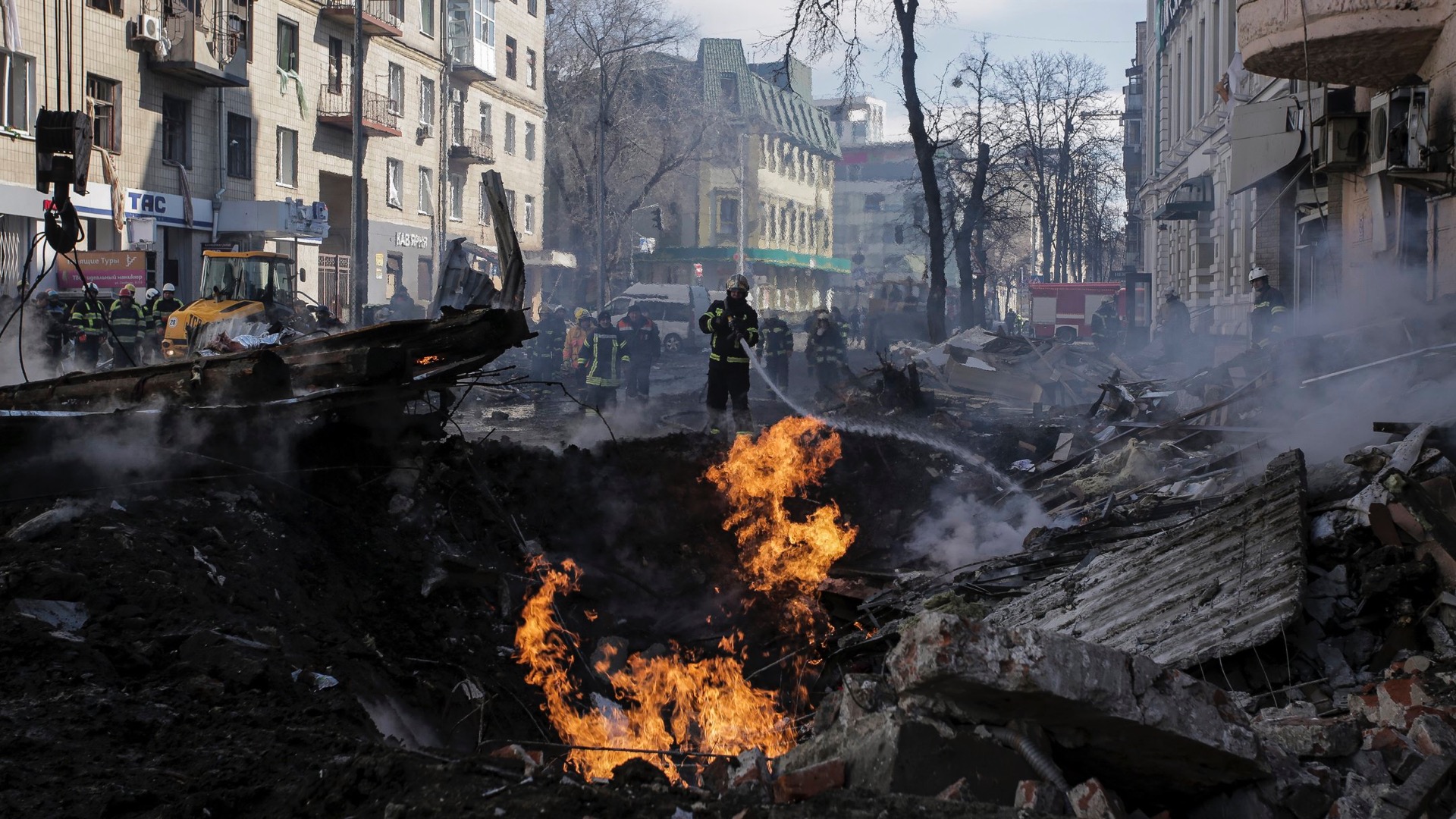 Firefighters extinguish flames outside an apartment house after a Russian rocket attack in Kharkiv, Ukraine's second-largest city, Ukraine, Monday, March 14, 2022. (AP Photo/Pavel Dorogoy)