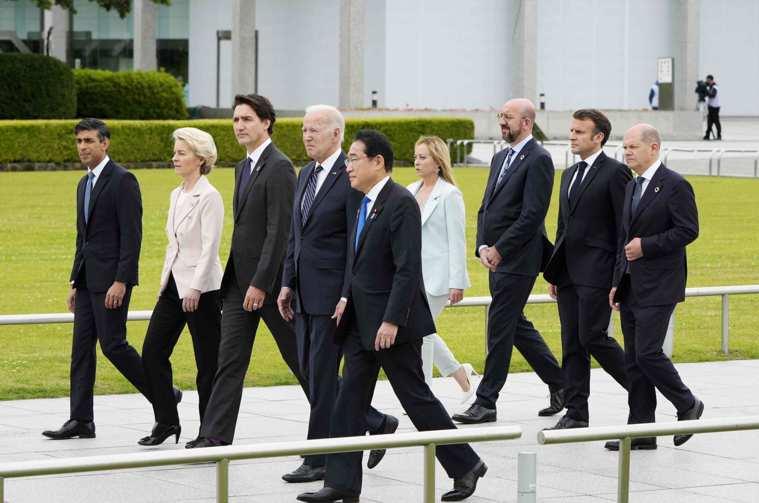 TOPSHOT - (L-R) British Prime Minister Rishi Sunak, European Commission President Ursula von der Leyen, Canadian Prime Minister Justin Trudeau, US President Joe Biden, Japan's Prime Minister Fumio Kishida, Italian Prime Minister Giorgia Meloni, European Council President Charles Michel, French President Emmanuel Macron, German Chancellor Olaf Scholz walk to a flower wreath laying ceremony at the Cenotaph for Atomic Bomb Victims in the Peace Memorial Park as part of the G7 Leaders' Summit in Hiroshima on May 19, 2023. (Photo by Franck ROBICHON / POOL / AFP) (Photo by FRANCK ROBICHON/POOL/AFP via Getty Images)
TOPSHOT-JAPAN-G7-SUMMIT